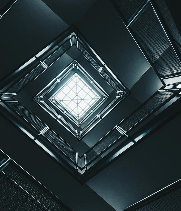 Abstract view of a geometric building interior looking up towards the sky, emphasizing modern architecture.